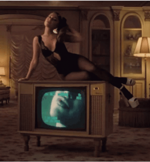 Fabulous Ariana Grande Sitting On Tv GIF