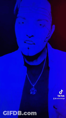 Face Lit Up With Blue Light Displaying TikTok GIF