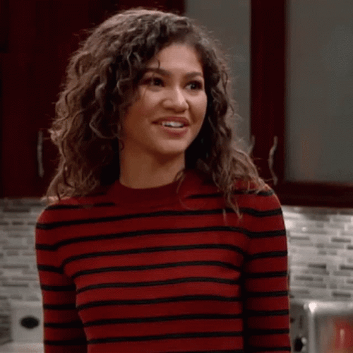 Fake Smile Shrugging Zendaya GIF