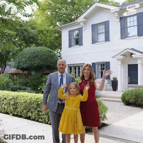 Family In Front Of House With Wife Swap Sign GIF
