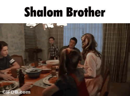 Family Sitting Around Table Saying Shalom Brother GIF