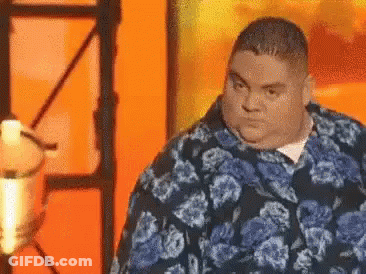 Fat Man In Blue Floral Shirt At Microphone GIF