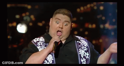 Fat Man Singing Into Microphone With Tongue Out GIF