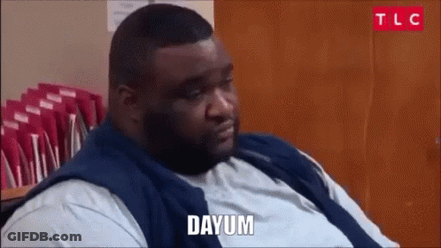 Fat Man Sitting In Front Of Wooden Door Saying Dayum GIF