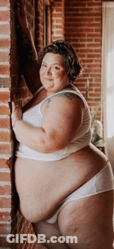 Fat Woman Leaning Against Brick Wall GIF