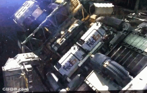 Fedex Boxes Are Stacked On Top Of Each Other In A Dark Room GIF