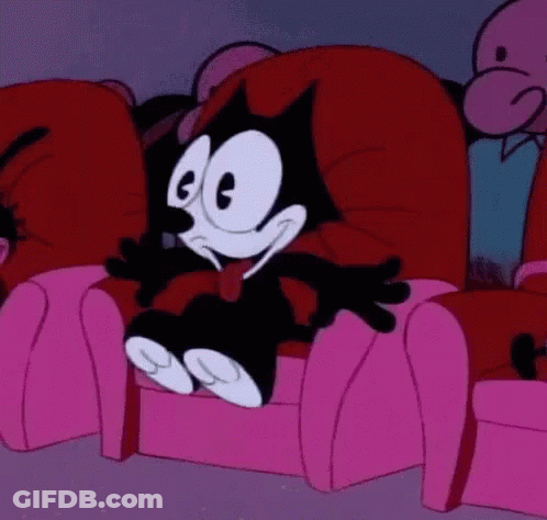 Felix The Cat Is Sitting In A Pink Chair In A Theater . GIF