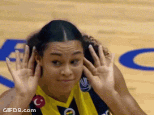 Female Basketball Player Covering Ears In Yellow Jersey GIF