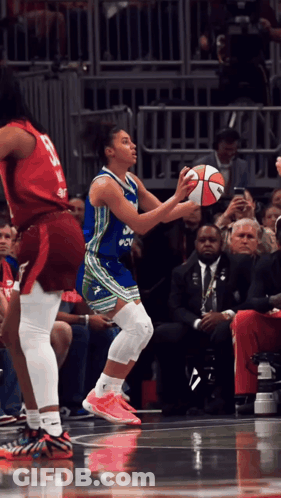 Female Basketball Player In Blue And Green PNV Uniform GIF