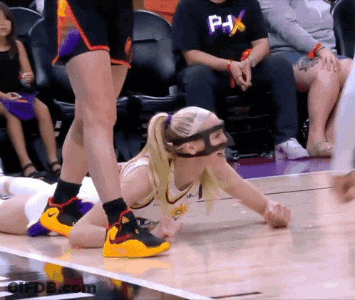 Female Basketball Player In Mask And PHX Shirt Lying On Floor GIF