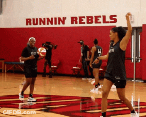 Female Basketball Players Practicing In Front Of Runnin' Rebels Wall GIF