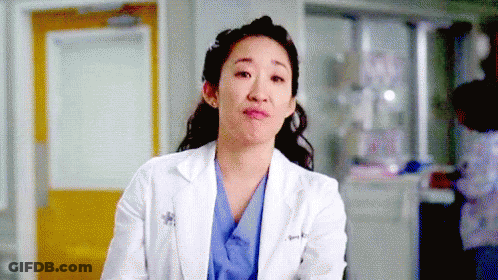 Female Doctor In White Lab Coat And Blue Scrubs Making Funny Face GIF