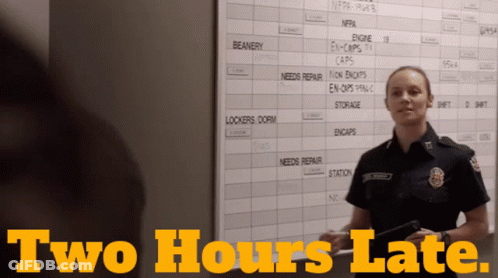 Female Firefighter In Front Of Board Saying Two Hours Late GIF