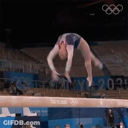 Female Gymnast Performing Balance Beam Trick GIF