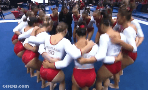 Female Gymnasts Huddled Uniform Says 50 GIF