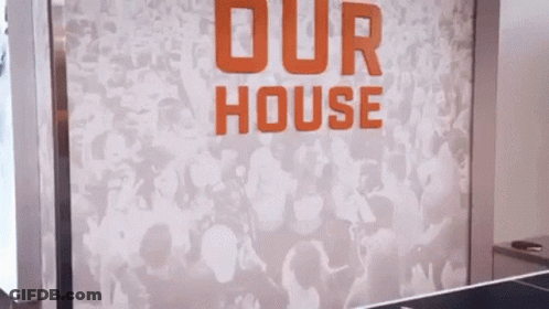 Female Referee Holding Basketball In Front Of Crowd GIF