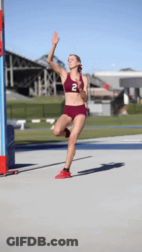 Female Runner In Maroon Top With Number 2 GIF