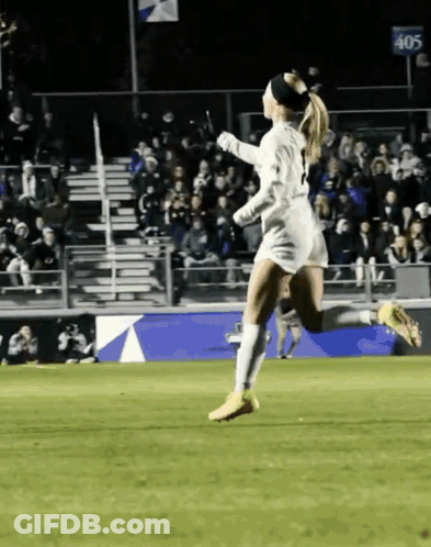 Female Soccer Player Running In Front Of 405 Sign GIF