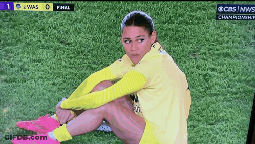Female Soccer Player Sits On Field During CBS News Championship Game GIF