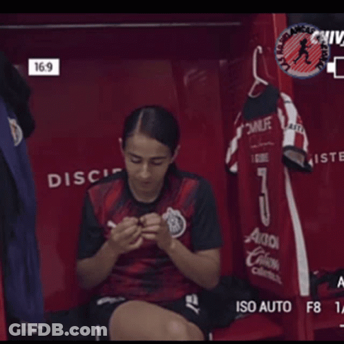 Female Soccer Player Sitting In Locker GIF