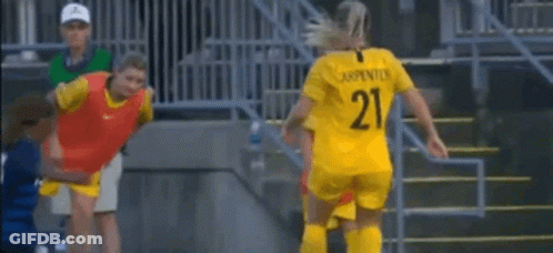 Female Soccer Players Around Referee GIF
