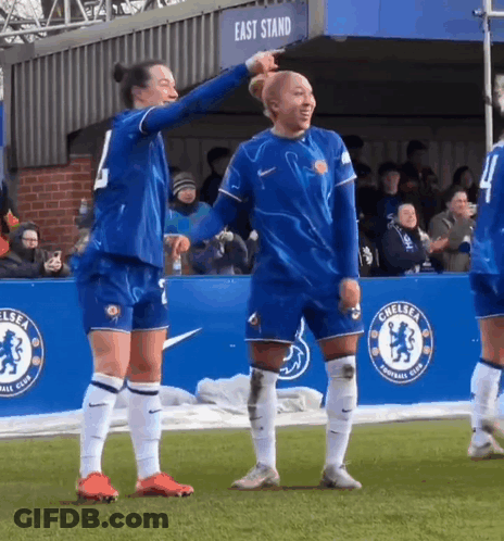 Female Soccer Players Standing In Front Of East Stand Banner GIF