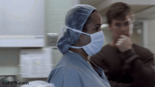 Female Surgeon In Surgical Cap And Mask GIF