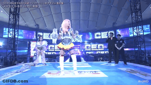 Female Wrestler In Front Of Screen Saying Strong GIF