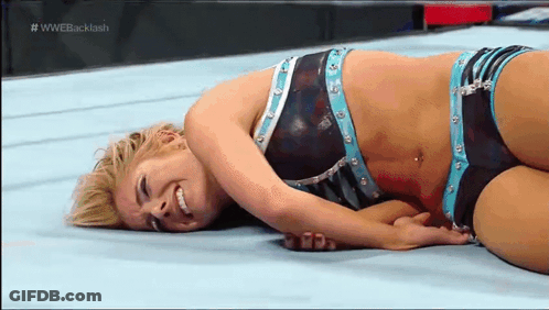 Female Wrestler Laying On Floor In Match GIF