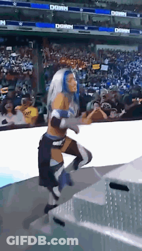 Female Wrestler Running On Stage With Crowd And Dawn Banner GIF