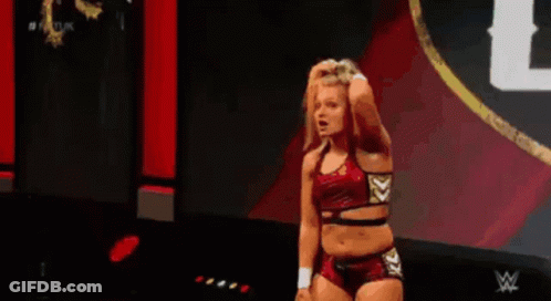 Female Wrestler Standing On Stage Holding Hair GIF
