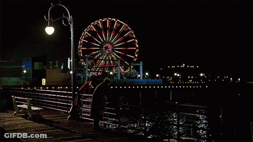 Ferris Wheel Lit Up At Night On Dock GIF