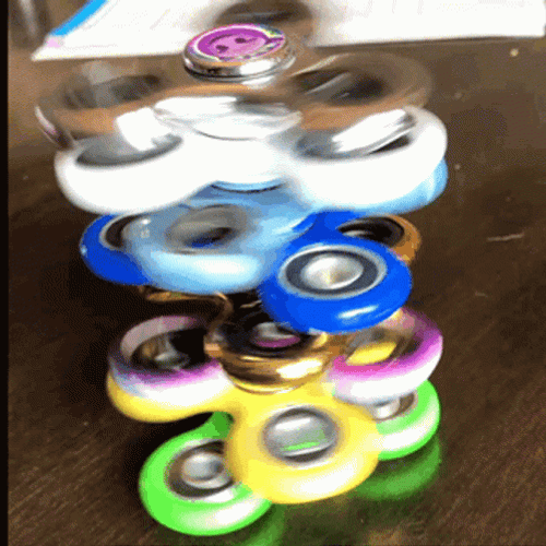 Fidget Toys Spinners On Table GIF