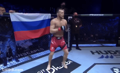 Fighter Holding Russian Flag In Cage GIF