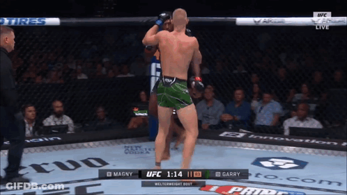 Fighter In Green Shorts Fighting Blue Shorts GIF