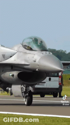 Fighter Jet Parked Next To Renault Van GIF
