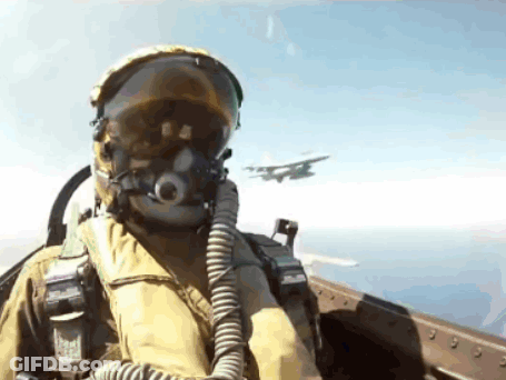Fighter Jet Pilot In Helmet And Goggles Flying GIF
