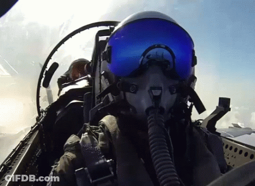 Fighter Jet Pilot In Helmet And Goggles Flying GIF