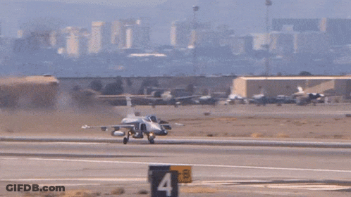 Fighter Jet Taking Off With Mountains And Buildings GIF