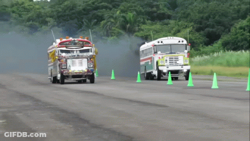 Fire Truck And School Bus Driving Past Green Cones GIF