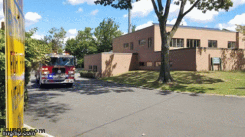 Fire Truck Parked In Front Of Building GIF