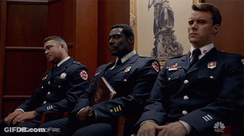 Firefighters Sitting In Courtroom GIF