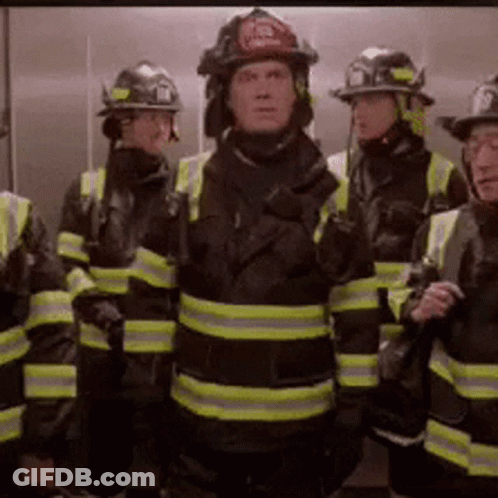 Firefighters Standing In Elevator With Helmets GIF