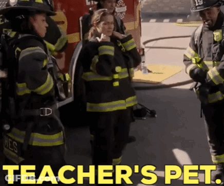 Firefighters Standing In Front Of Fire Truck Saying Teacher's Pet GIF