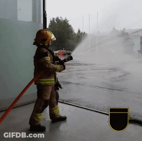 Fireman In Yellow Helmet 510 Spraying Water GIF