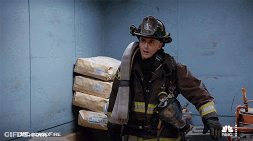 Fireman Standing In Front Of Bags With #Chicagofire GIF