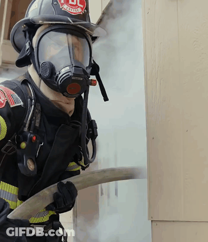 Fireman Wearing Mask And Helmet Saying UL GIF
