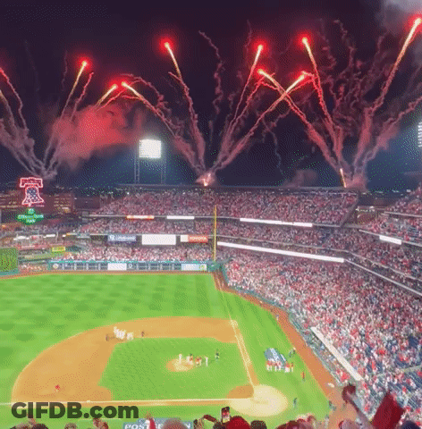 Fireworks Are Displayed Over A Baseball Field With A Post Advertisement GIF