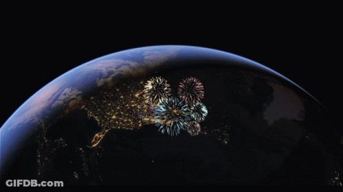 Fireworks Are Displayed Over The Earth In A Dark Sky GIF