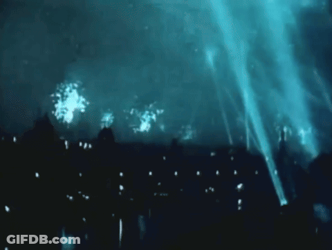Fireworks In Night Sky Over Buildings GIF